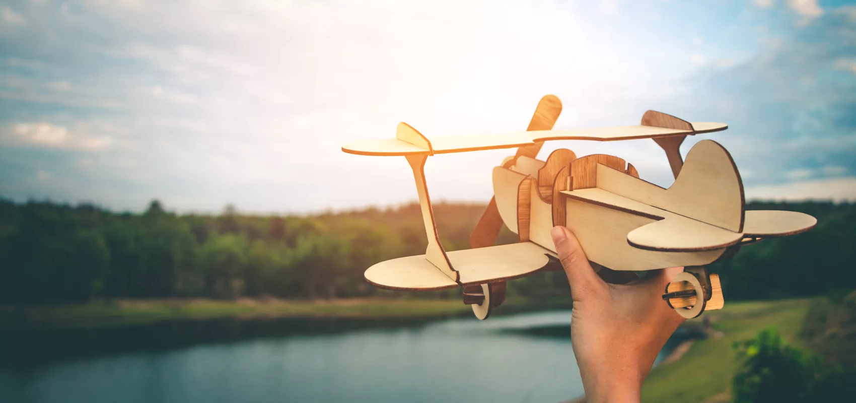 envol-breathwork une avion en bois tenu en main pour un envol